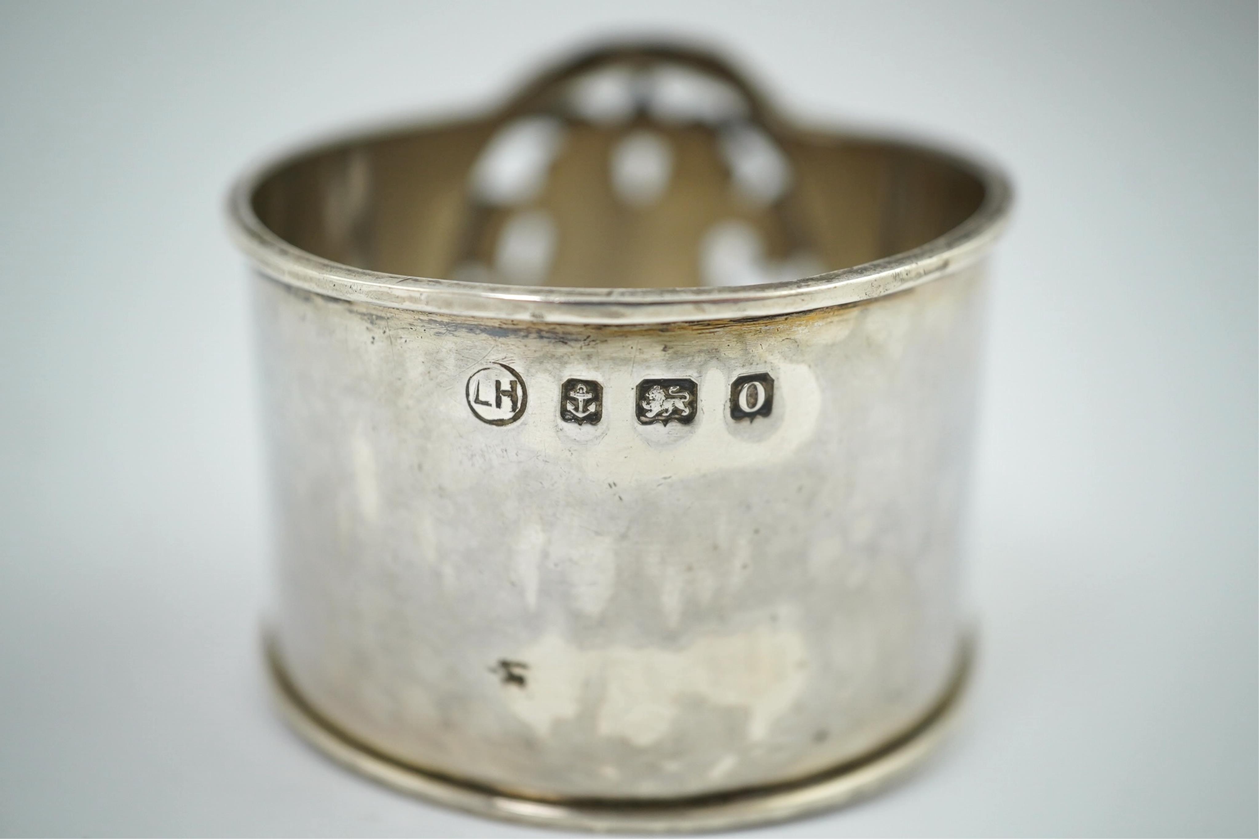 An Arts and Crafts silver and enamel napkin ring, maker’s mark LH, Birmingham 1938, 4.5cm high. Condition - fair